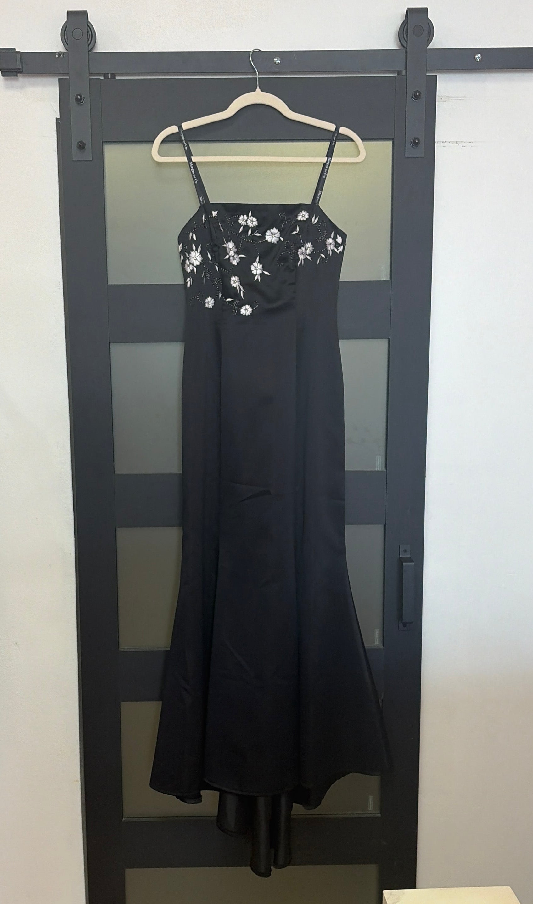 Black floor length evening gown with floral detailing