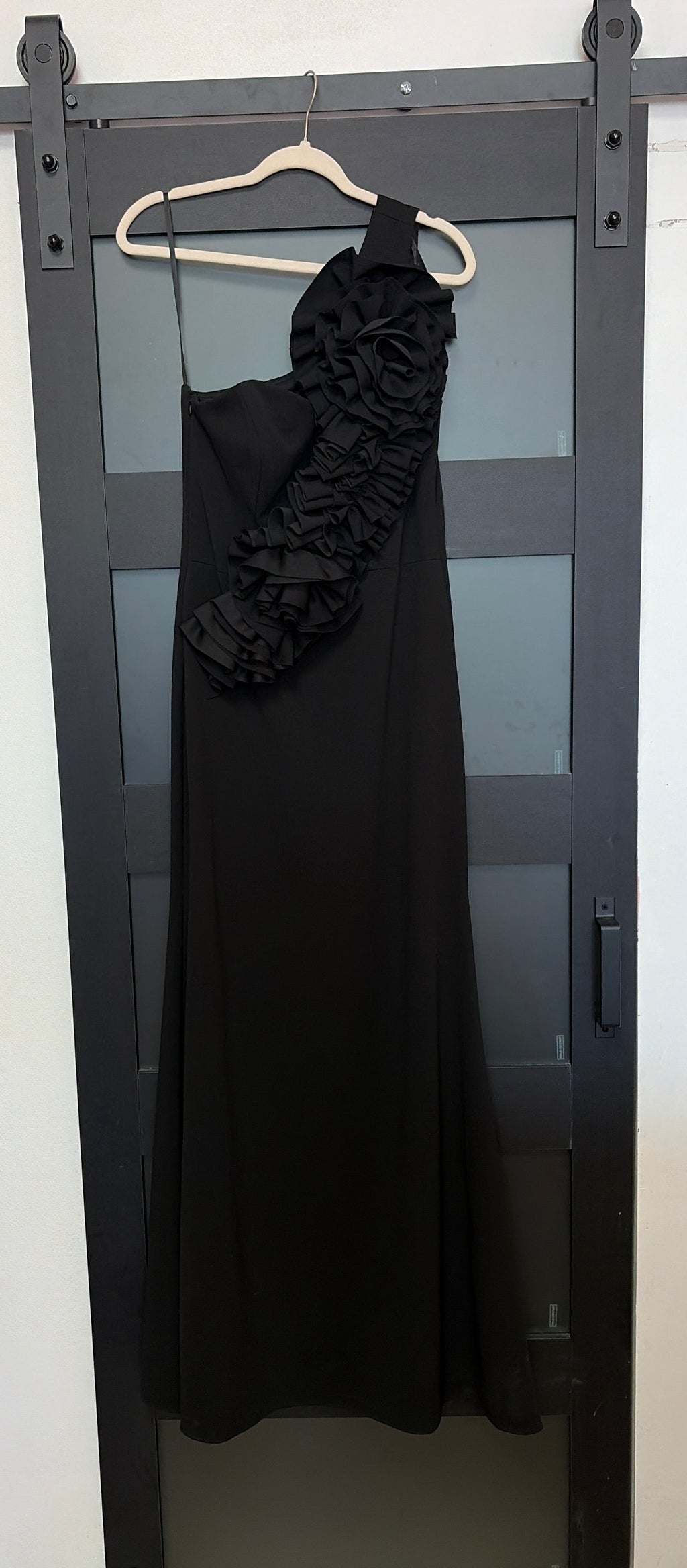 Betsy & Adam black one shoulder gown with floral detail across chest