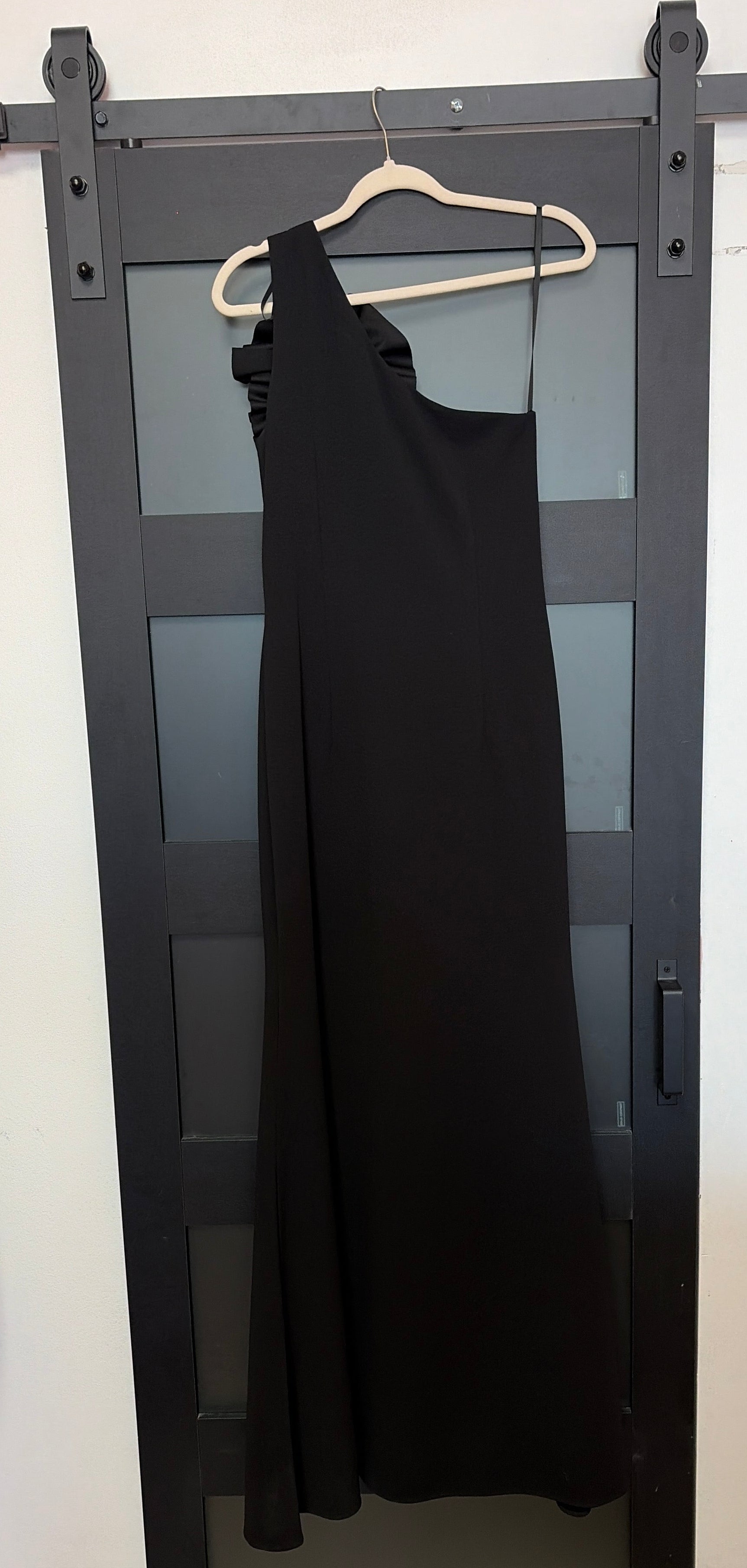 Betsy & Adam black one shoulder gown with floral detail across chest